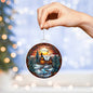 Beautiful Acrylic Ornament with a Stained Glass Look of: a Cozy Cabin on a River with Santa & Reindeer silhouette over moon